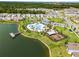 An aerial view of a community park and pool area with playground, pier, and residences nearby at 4829 Cedar Bay Ter, Kissimmee, FL 34746