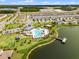 An aerial view of a neighborhood pool, recreation areas, and lake access enhancing community living at 4829 Cedar Bay Ter, Kissimmee, FL 34746