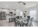 Modern dining area adjacent to the kitchen features stainless steel appliances and counter seating, all in a modern design at 4829 Cedar Bay Ter, Kissimmee, FL 34746