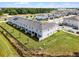 A row of light-colored townhomes features well-kept lawns, complemented by a community with sidewalks and street parking at 4829 Cedar Bay Ter, Kissimmee, FL 34746