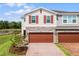 Charming townhome with stone accents, brick driveway, and a two-car garage overlooking beautiful landscaping at 4829 Cedar Bay Ter, Kissimmee, FL 34746