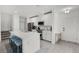 Modern kitchen featuring a breakfast bar, stainless steel appliances, and ample cabinet space with a view of the front entry at 4829 Cedar Bay Ter, Kissimmee, FL 34746