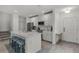 Open kitchen with white cabinets, stainless steel appliances, large island, and eat-in breakfast bar at 4829 Cedar Bay Ter, Kissimmee, FL 34746