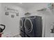 Well-lit laundry room with modern washer and dryer units and shelf at 4829 Cedar Bay Ter, Kissimmee, FL 34746
