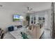 Bright living room with large windows, modern ceiling fan and a flat screen television at 4829 Cedar Bay Ter, Kissimmee, FL 34746