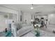 Bright living room flowing to the kitchen featuring white cabinets and modern appliances at 4829 Cedar Bay Ter, Kissimmee, FL 34746