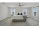 Spacious main bedroom with large windows, plush carpet and chandelier ceiling fan at 4829 Cedar Bay Ter, Kissimmee, FL 34746