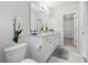 Bathroom features double sink vanity, neutral color scheme, and ample lighting at 5079 Royal Point Ave, Kissimmee, FL 34746