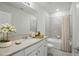 Well-lit bathroom featuring a single sink vanity, a mirror, and tiled shower for a clean and modern feel at 5079 Royal Point Ave, Kissimmee, FL 34746
