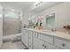 Spacious bathroom featuring double sink vanity, tiled shower, and ample counter space, offering a luxurious spa-like experience at 5079 Royal Point Ave, Kissimmee, FL 34746