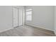 Light bedroom with wood floors, closet and a window at 5079 Royal Point Ave, Kissimmee, FL 34746