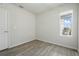 Bedroom with light wood flooring and a window with natural sunlight at 5079 Royal Point Ave, Kissimmee, FL 34746