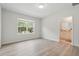 Bright bedroom with wood floors, and window looking out onto the mature landscaping at 5079 Royal Point Ave, Kissimmee, FL 34746