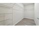 Walk-in closet featuring wood floors and metal shelving at 5079 Royal Point Ave, Kissimmee, FL 34746