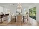 Elegant dining area with a glass-top table and stylish chairs, bathed in natural light from the sliding glass door at 5079 Royal Point Ave, Kissimmee, FL 34746