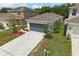 Charming one-story home with a well-manicured lawn and a spacious two-car garage at 5079 Royal Point Ave, Kissimmee, FL 34746