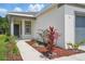 The walkway leads to the front door surrounded by fresh mulch and mature landscaping at 5079 Royal Point Ave, Kissimmee, FL 34746