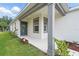 Covered front porch with a gray accent pillar offers shade and shelter near the home's entrance at 5079 Royal Point Ave, Kissimmee, FL 34746