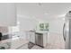 Open concept kitchen features a center island with a stainless dishwasher and sink at 5079 Royal Point Ave, Kissimmee, FL 34746