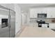 Bright kitchen features stainless steel appliances, white cabinets and countertops at 5079 Royal Point Ave, Kissimmee, FL 34746