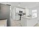 Kitchen with stainless steel appliances, center island and white cabinetry at 5079 Royal Point Ave, Kissimmee, FL 34746