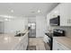 Open concept kitchen with large island and stainless steel refrigerator at 5079 Royal Point Ave, Kissimmee, FL 34746