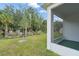 The screened lanai overlooks a grassy backyard with mature trees at 5079 Royal Point Ave, Kissimmee, FL 34746