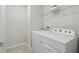 Functional laundry area featuring a white washer and dryer with shelf for linen storage at 5079 Royal Point Ave, Kissimmee, FL 34746
