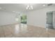 Spacious living room with tile flooring and sliding doors to the patio at 5079 Royal Point Ave, Kissimmee, FL 34746