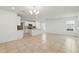 Open living space with kitchen, featuring tile floors and a kitchen island at 5079 Royal Point Ave, Kissimmee, FL 34746