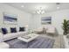 Bright living room with white sofa, stylish decor, and neutral walls, perfect for relaxing or entertaining guests at 5079 Royal Point Ave, Kissimmee, FL 34746