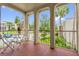 View of the outdoor balcony with table and chairs, overlooking the building's landscaped yard at 514 Orange Dr # 31, Altamonte Springs, FL 32701