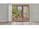 View from inside of sliding glass door onto outdoor balcony with terracotta tiling and outdoor seating at 514 Orange Dr # 31, Altamonte Springs, FL 32701