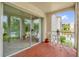 Outdoor balcony with red tile and furniture, partially covered by a large sliding glass door at 514 Orange Dr # 31, Altamonte Springs, FL 32701