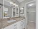 Bathroom with granite countertop, modern fixtures, and view of walk-in closet at 514 Orange Dr # 31, Altamonte Springs, FL 32701