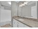 Bright bathroom with a white vanity, granite countertop, and a large mirror with decorative lighting at 514 Orange Dr # 31, Altamonte Springs, FL 32701