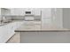 Bright kitchen with stone countertops and white appliances provides a clean and updated space at 514 Orange Dr # 31, Altamonte Springs, FL 32701