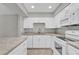 Updated kitchen featuring stone countertops, white cabinetry, and stainless-steel appliances at 514 Orange Dr # 31, Altamonte Springs, FL 32701