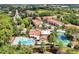 Community aerial view with pool, tennis court, clubhouse, and lush landscaping at 5168 Conroy Rd # 35, Orlando, FL 32811