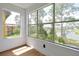 Bedroom with expansive windows framing picturesque lake and treetop views at 5168 Conroy Rd # 35, Orlando, FL 32811