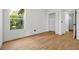 Bedroom with light wood floors and a window providing natural light at 5168 Conroy Rd # 35, Orlando, FL 32811