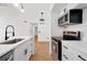 Well-lit kitchen featuring white cabinets, new appliances, and an open layout at 5168 Conroy Rd # 35, Orlando, FL 32811