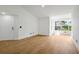 Well-lit living room features light wood floors, a bright window, and a front door at 5168 Conroy Rd # 35, Orlando, FL 32811