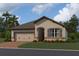 Charming single-story home featuring a two-car garage, and stone accents at 5250 Teirgarten St, St Cloud, FL 34771