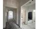 Unfinished hallway view showcasing the home's layout with multiple rooms and an archway to a room with windows at 5250 Teirgarten St, St Cloud, FL 34771