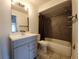 Neutral-toned bathroom featuring a single sink vanity and a shower-tub combination at 53 W Marbrisa Way, Kissimmee, FL 34743
