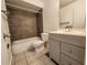 Modern bathroom featuring a stylish vanity, toilet, and tiled shower/tub at 53 W Marbrisa Way, Kissimmee, FL 34743