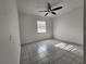 Bright bedroom showcasing neutral walls, tile flooring, and a ceiling fan at 53 W Marbrisa Way, Kissimmee, FL 34743