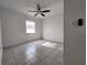 Bright bedroom showcasing neutral walls, tile flooring, and a ceiling fan at 53 W Marbrisa Way, Kissimmee, FL 34743