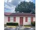 Charming single-story home with a red door, red shutters and a well-manicured lawn at 53 W Marbrisa Way, Kissimmee, FL 34743